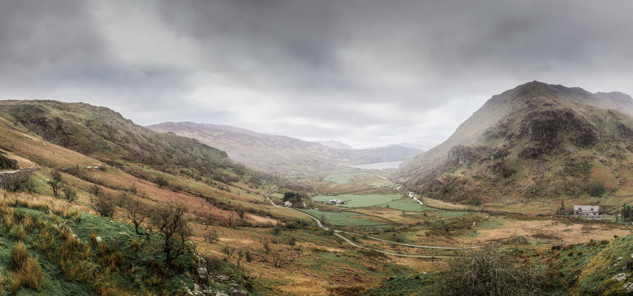 Scenic view of mountains against cloudy sky