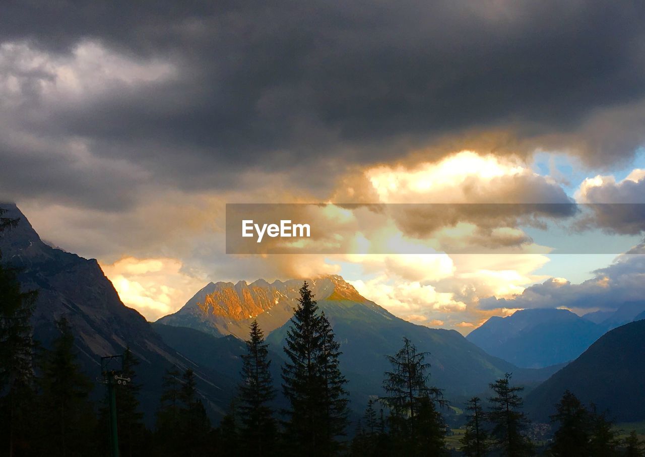 Scenic view of snowcapped mountains against sky at dusk