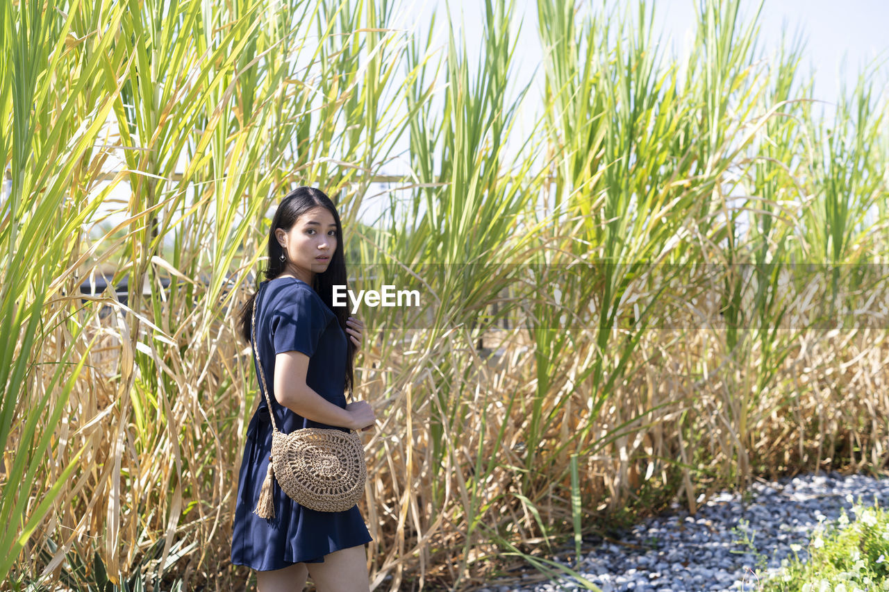 Full length of woman standing on grass.