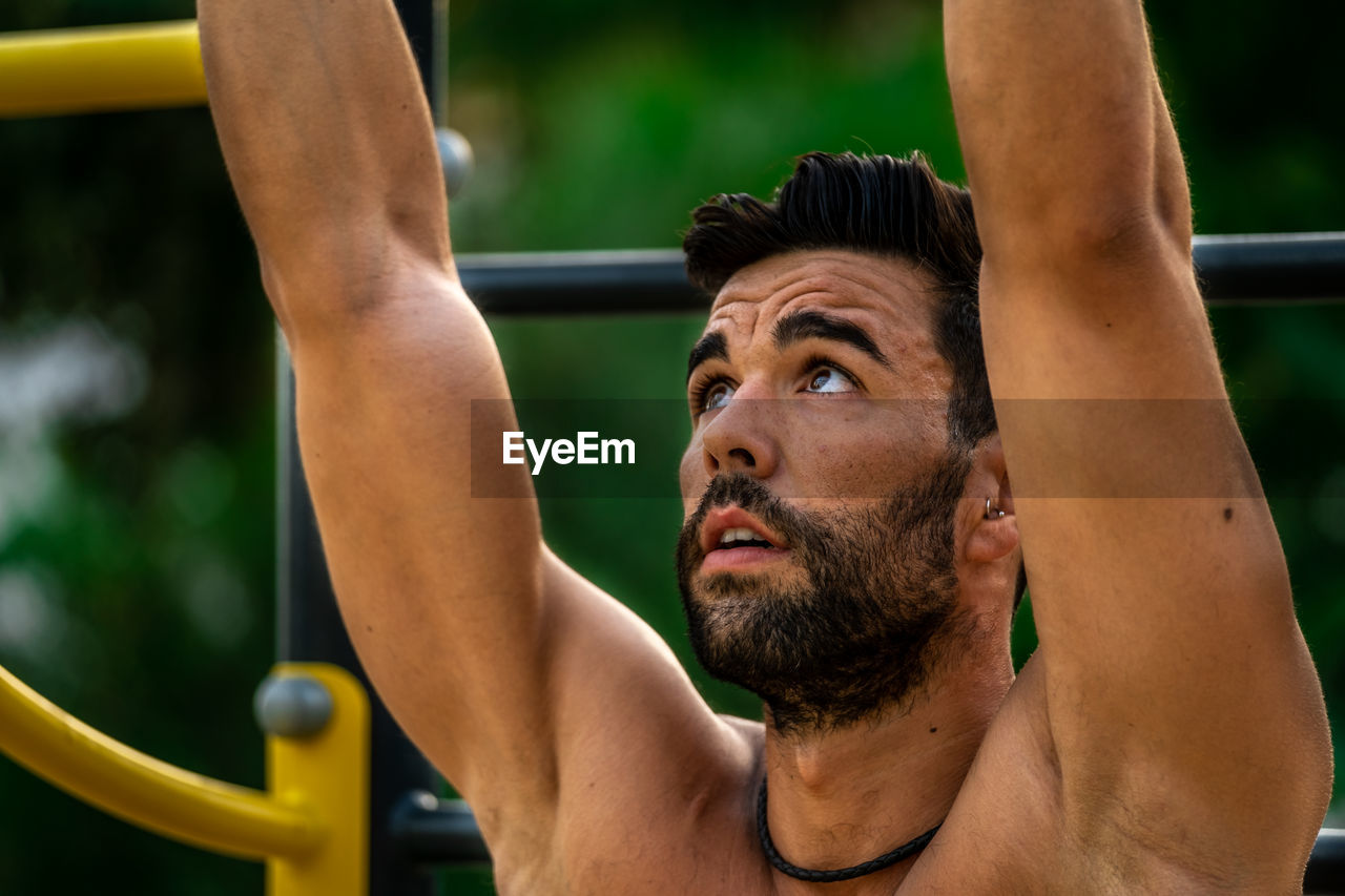 Close-up of young man wearing exercising outdoors