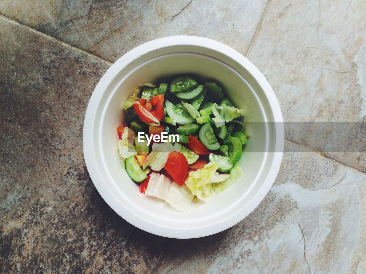 High angle view of vegetable salad in bowl on floor