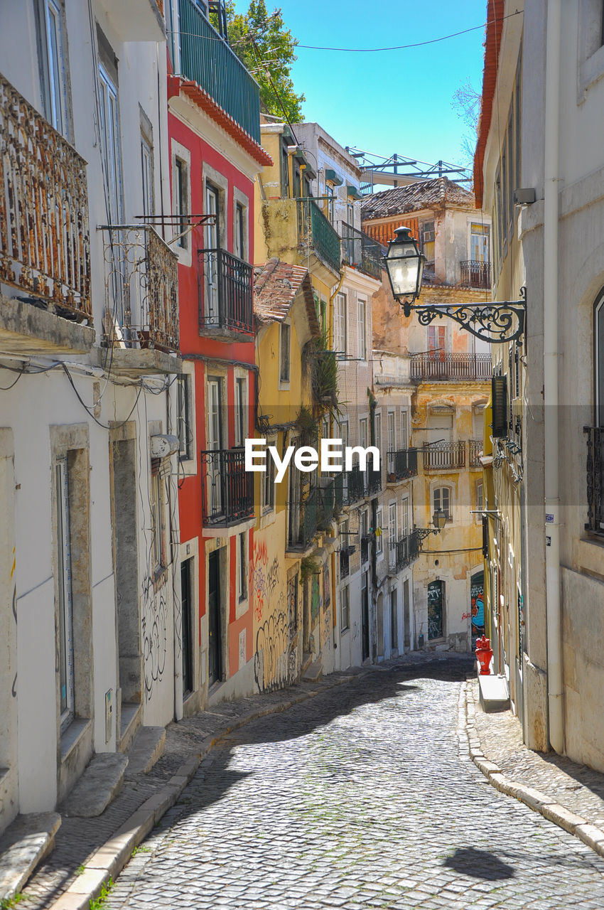 Narrow street amidst buildings in town
