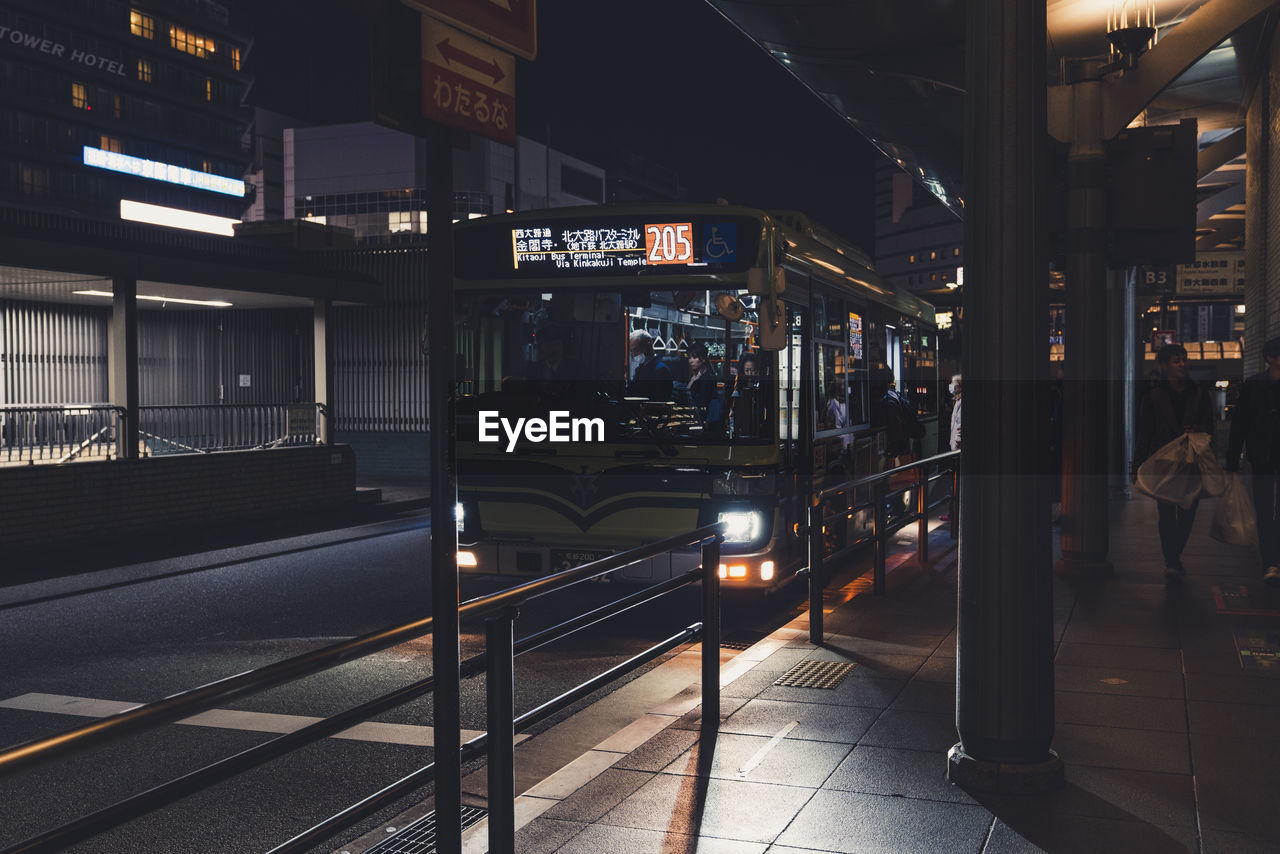 TRAIN ON RAILROAD STATION PLATFORM AT NIGHT