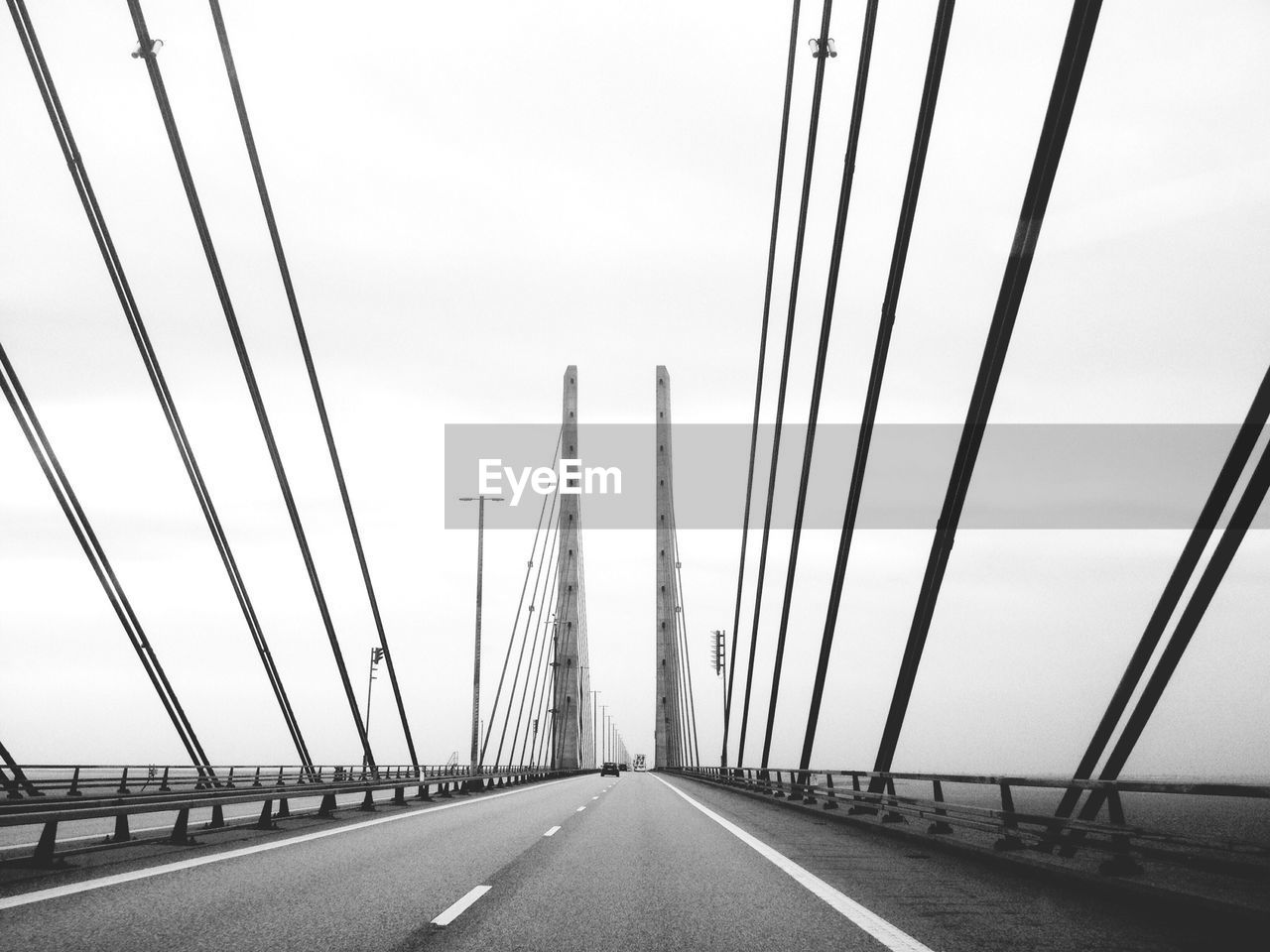 Cables and towers of bridge against sky
