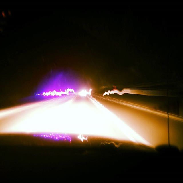 LIGHT TRAILS ON ROAD AT NIGHT