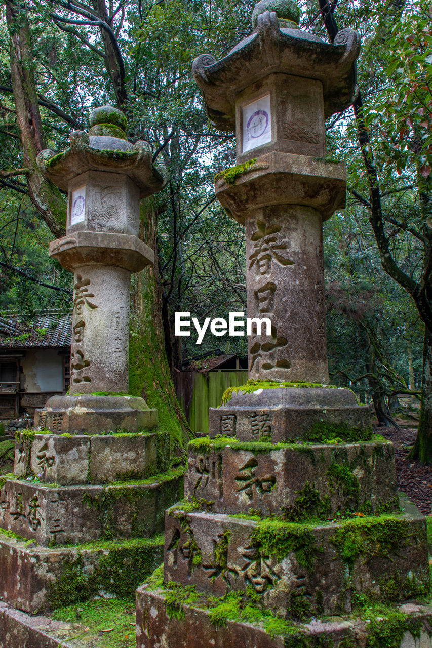 LOW ANGLE VIEW OF CROSS ON STONE TEMPLE