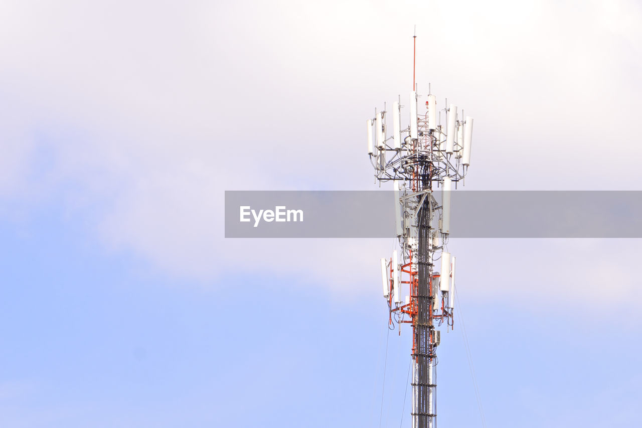 LOW ANGLE VIEW OF COMMUNICATIONS TOWER AGAINST SKY IN BACKGROUND