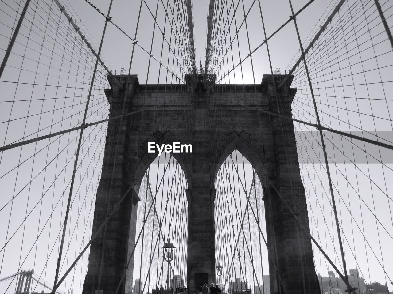 Low angle view of brooklyn bridge against sky in city