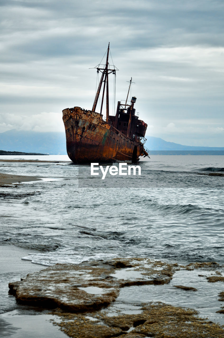 BOAT ON SEA AGAINST SKY