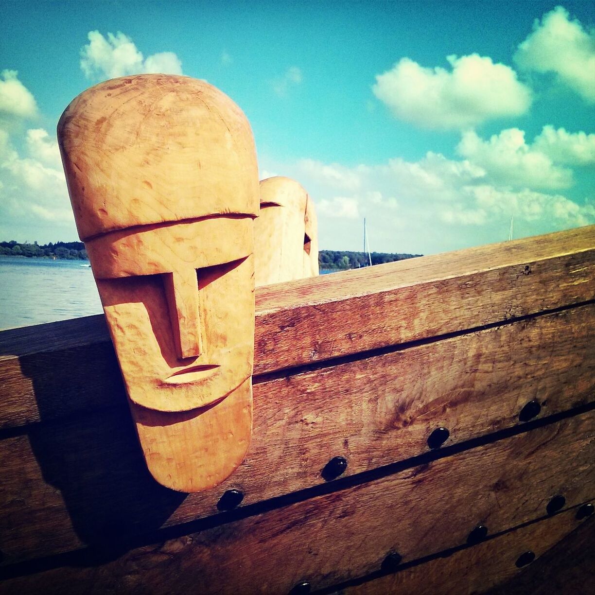 Close-up of wooden faces on ship