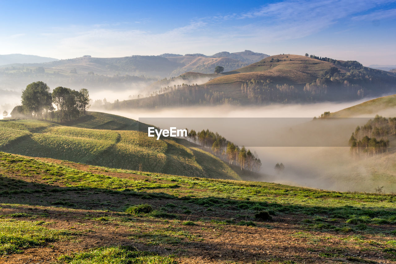 Scenic view of landscape and mountains against sky