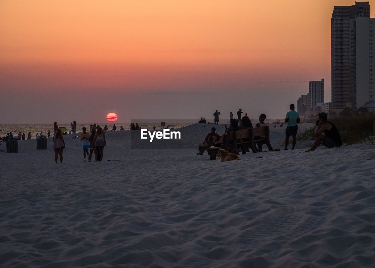 PEOPLE AT BEACH DURING SUNSET