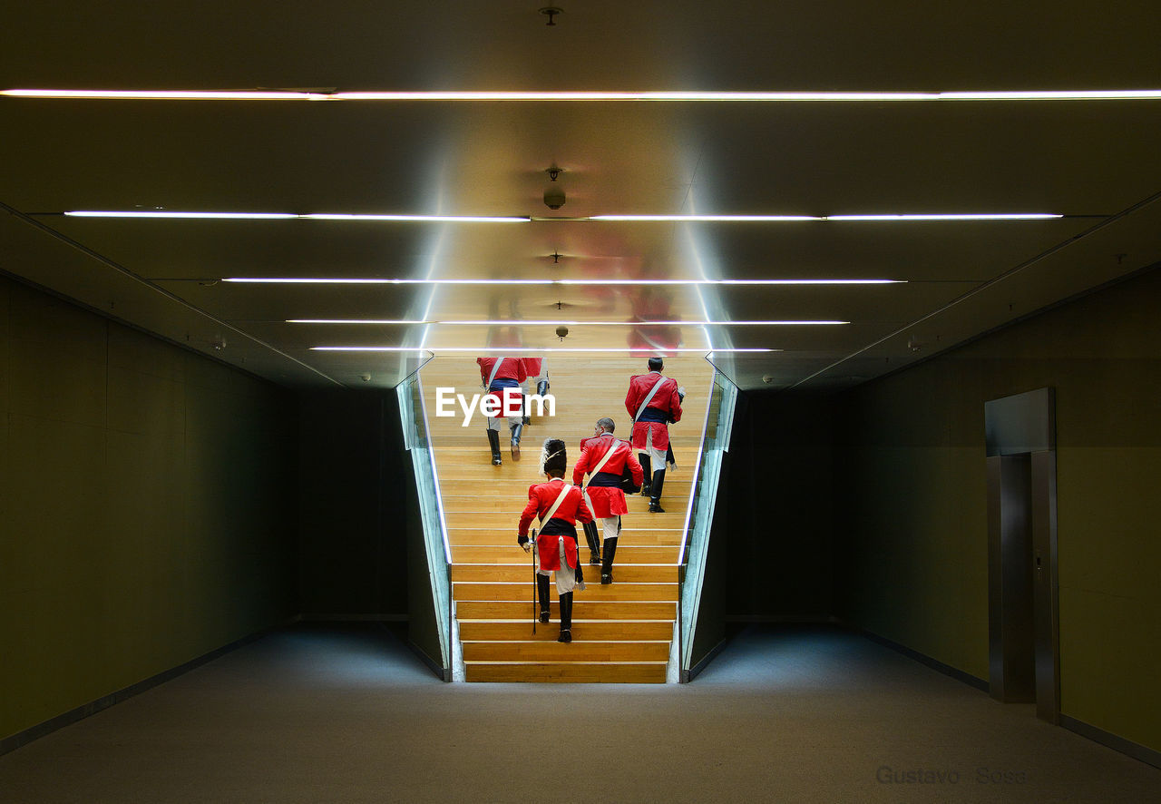 Rear view of grenadiers on staircase in government building