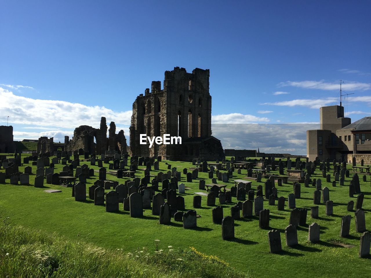 High angle view of cemetery by old ruins against sky