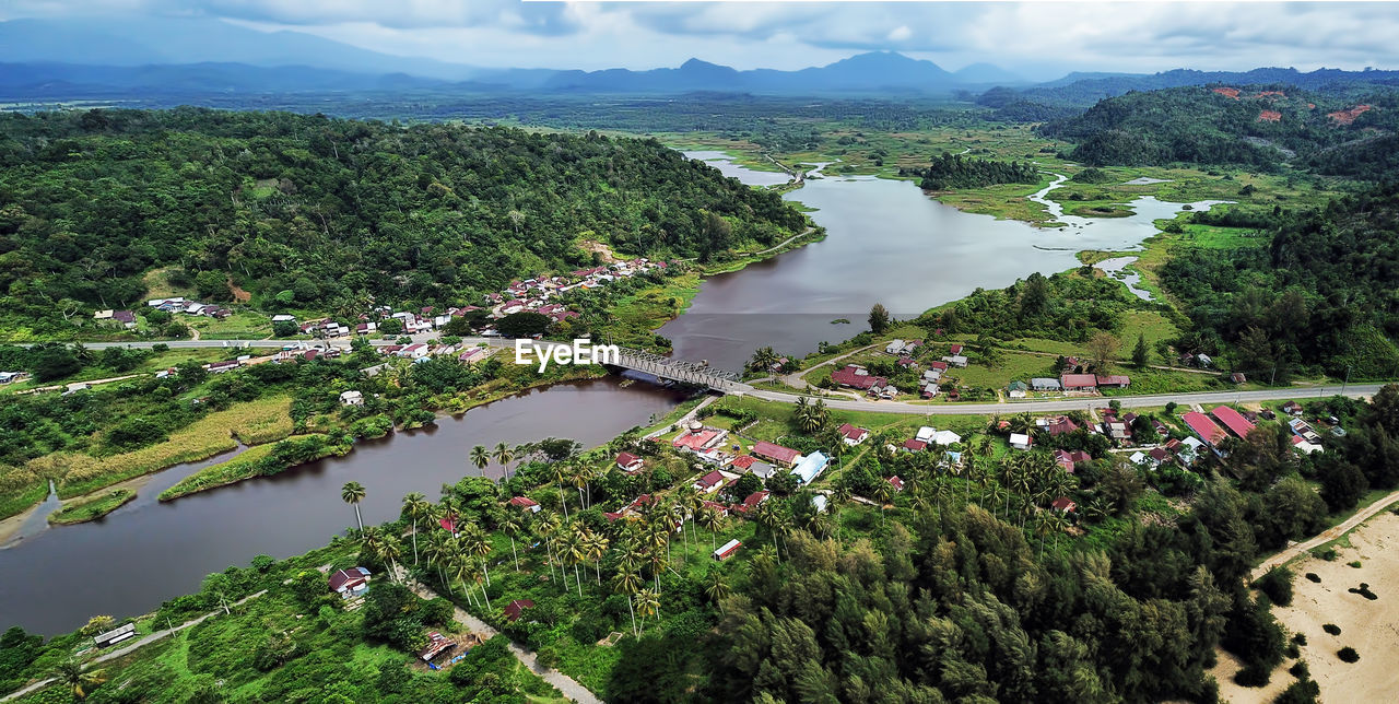 aerial photography, water, plant, environment, tree, nature, landscape, scenics - nature, high angle view, beauty in nature, land, sky, cloud, river, bird's-eye view, architecture, travel, aerial view, travel destinations, outdoors, city, mountain, built structure, day, tourism, no people, green, building, reservoir, tranquility, transportation, forest, building exterior, growth, rural scene, mountain range, rural area, social issues, tranquil scene, town, beach, agriculture