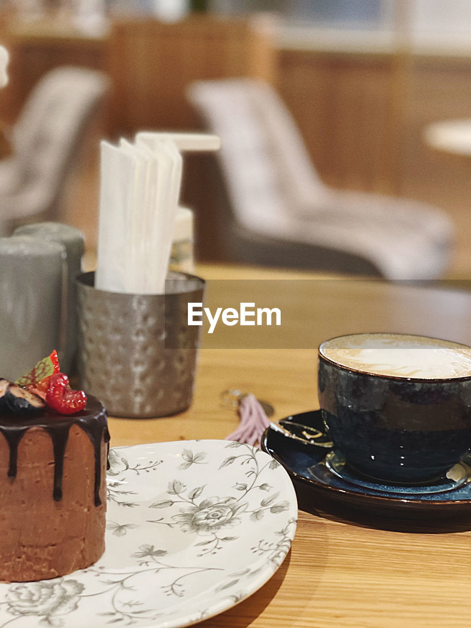 CLOSE-UP OF COFFEE CUP AND TABLE