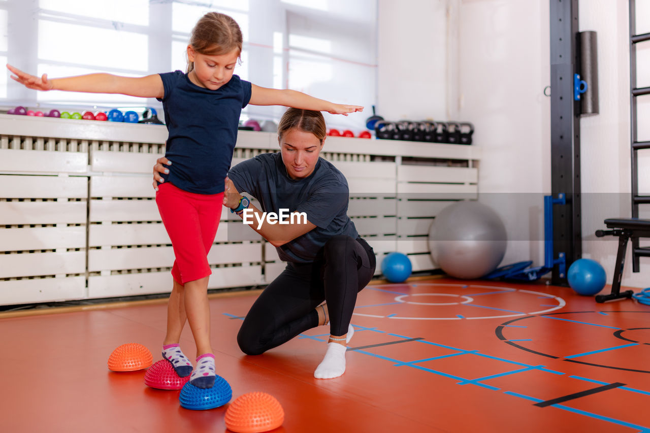 Child training for balance improvement and flat feet correction, walking over spiked half-balls