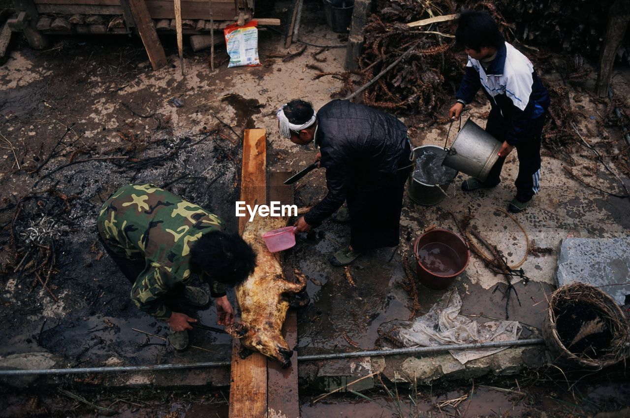 HIGH ANGLE VIEW OF PEOPLE WORKING IN TRADITIONAL CLOTHING