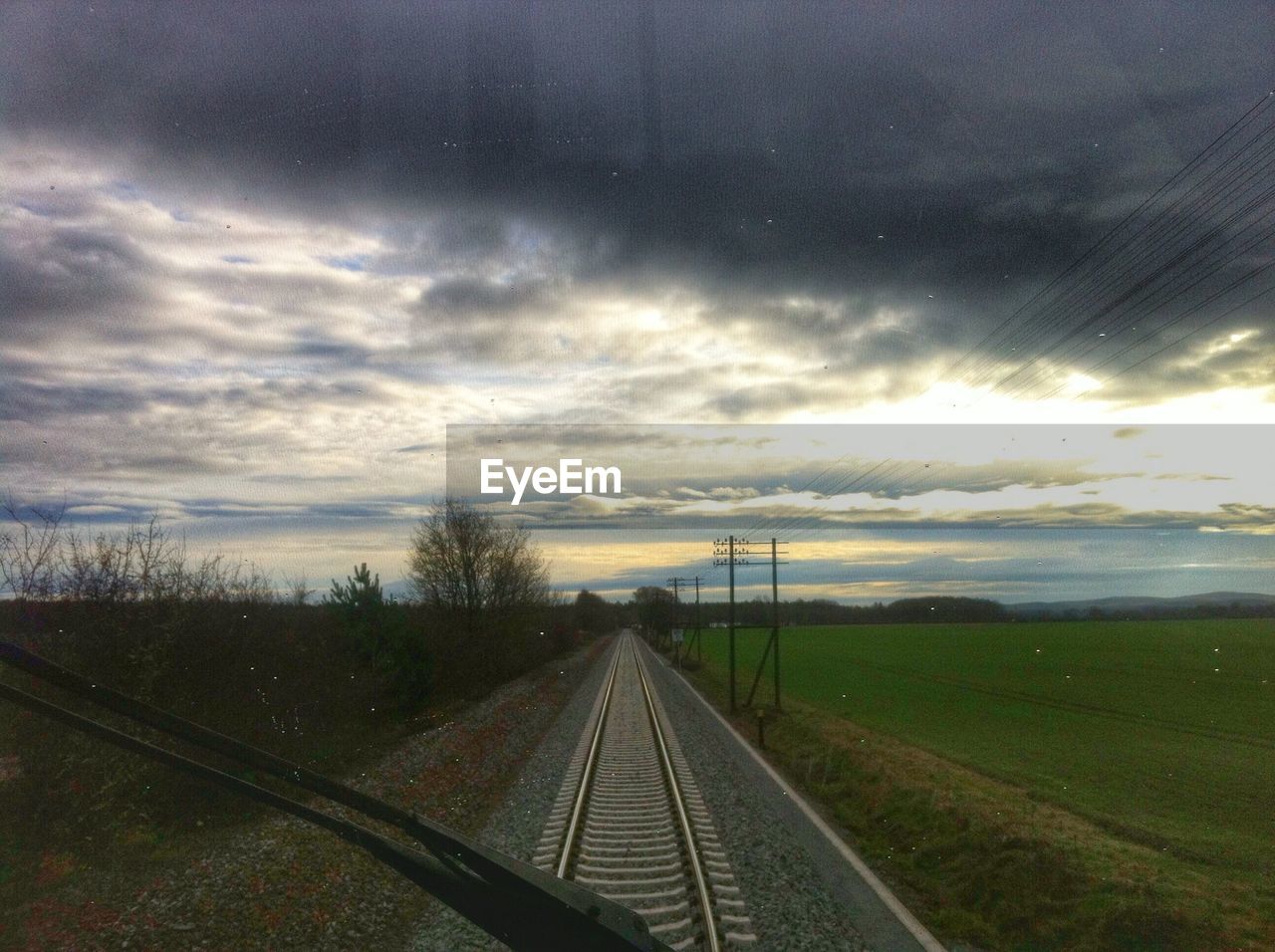 Scenic view of field through train windshield