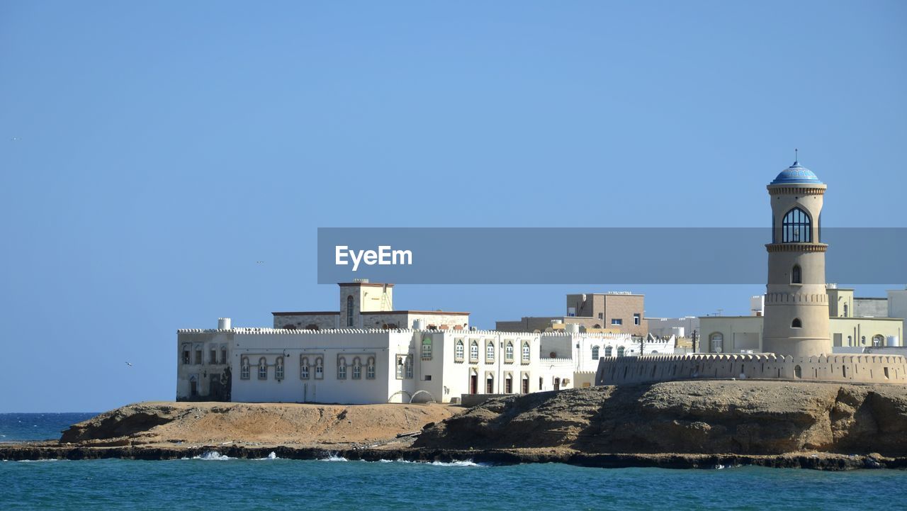 Scenic view of calm sea against clear blue sky