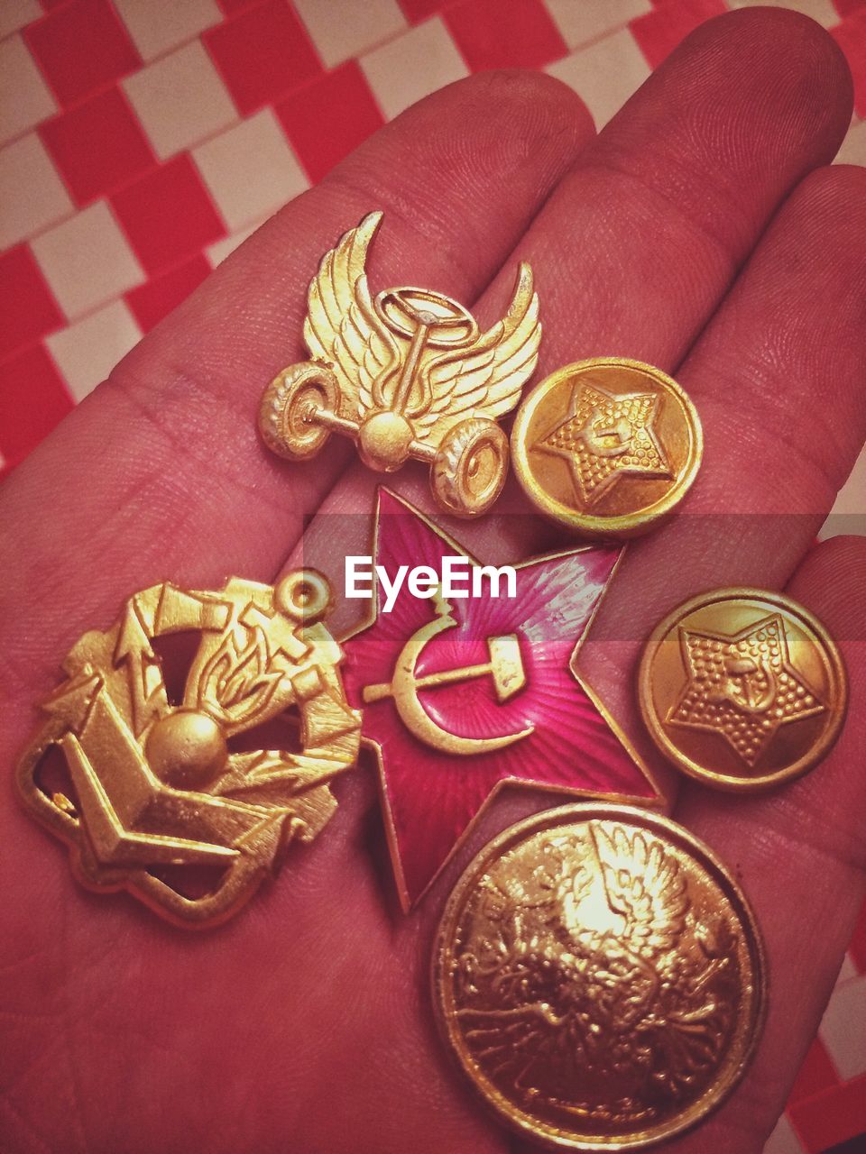 Cropped hand showing various badges