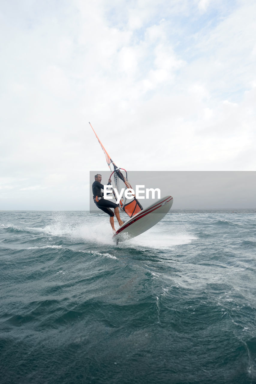 VIEW OF PERSON ON SEA AGAINST SKY