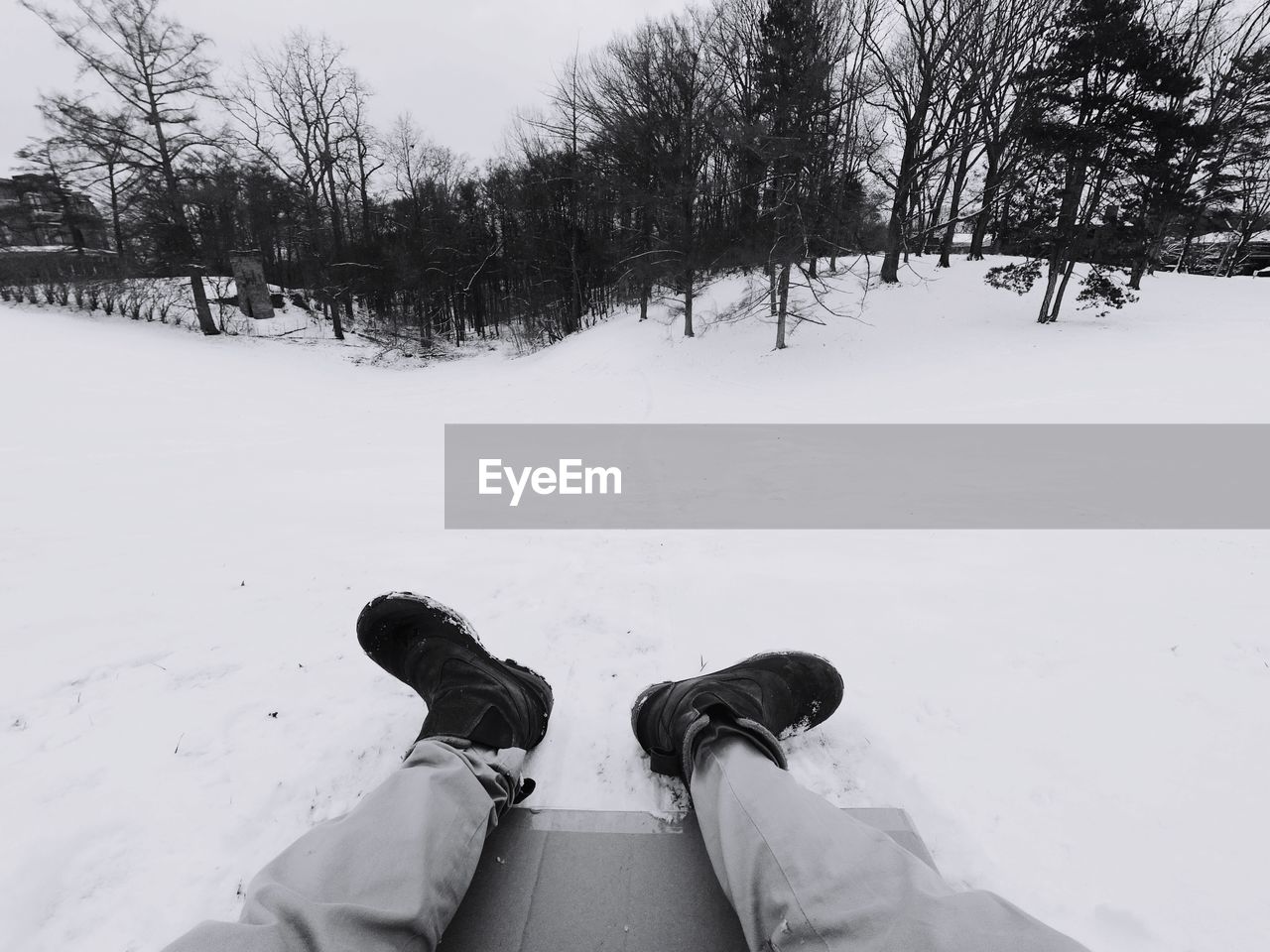 Low section of man on snow covered field