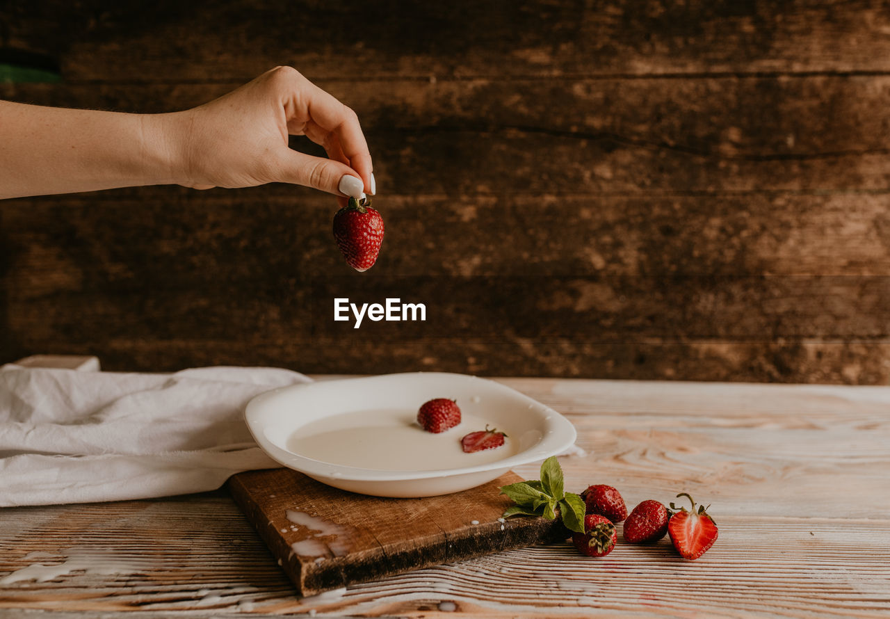 cropped hands of person preparing food at table