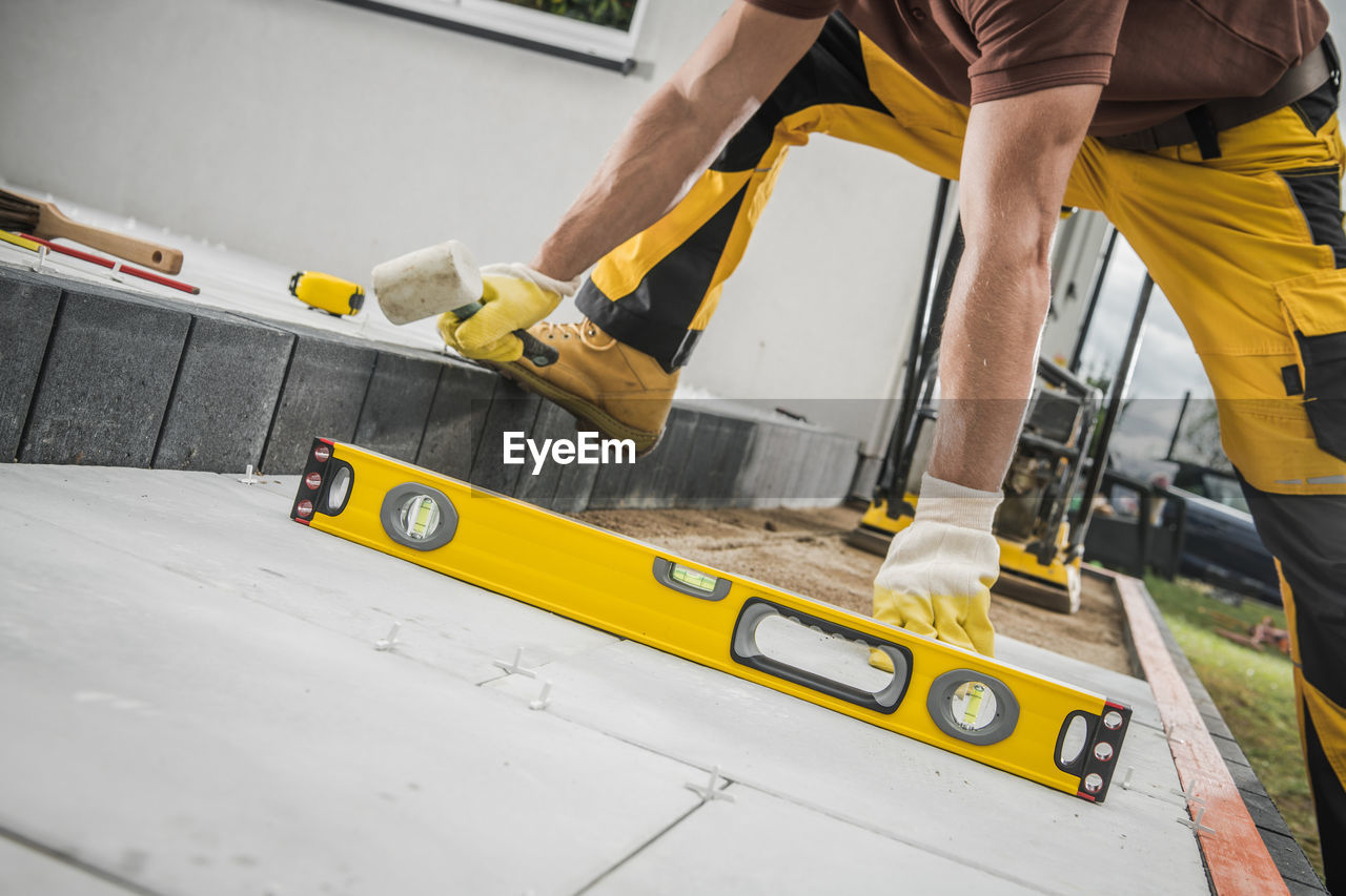 low section of man working at construction site