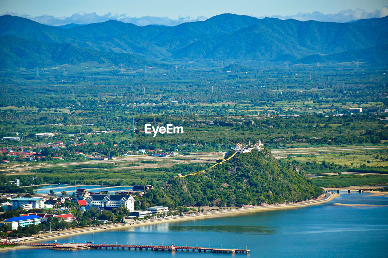 HIGH ANGLE VIEW OF TREES AND MOUNTAINS AGAINST SKY