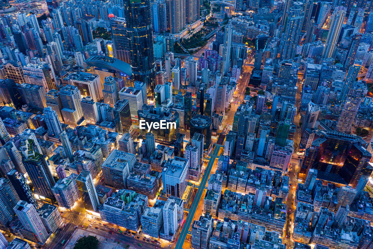 Aerial view of buildings in city against sky at dusk