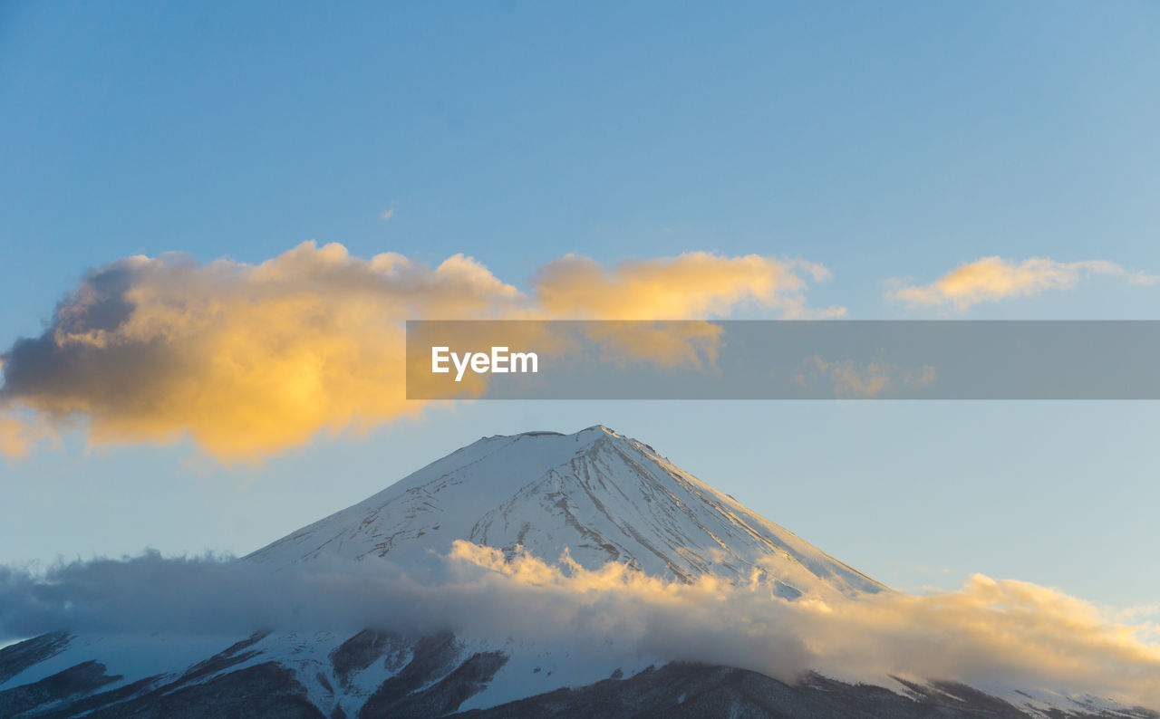 Scenic view of snowcapped mountains against sky during sunset