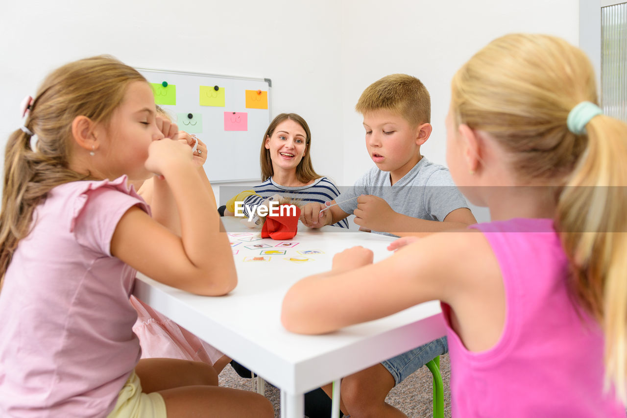 Child occupational therapy session. group of children doing playful exercises with their therapist.