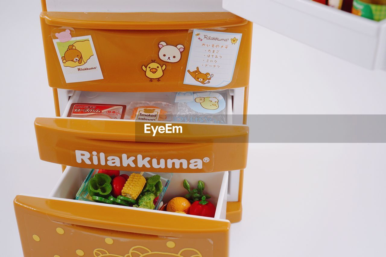 CLOSE-UP OF FRUITS IN BOX AGAINST WHITE BACKGROUND