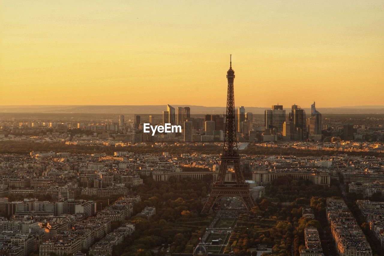 Aerial view of buildings in city during sunset