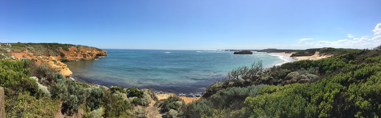 Panoramic view of sea against clear blue sky