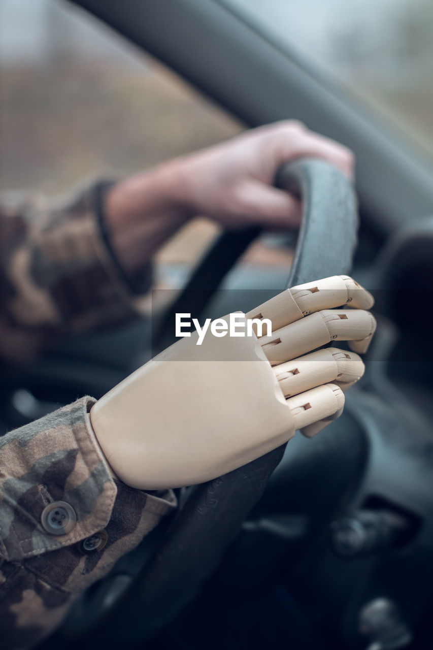 Soldier with artificial hand driving car