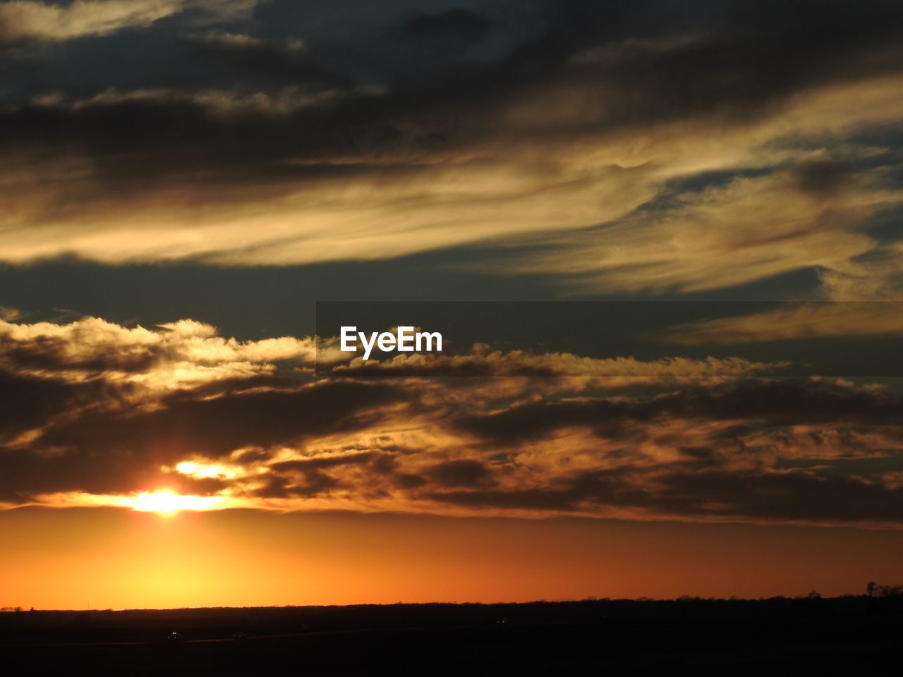 DRAMATIC SKY OVER SILHOUETTE LANDSCAPE