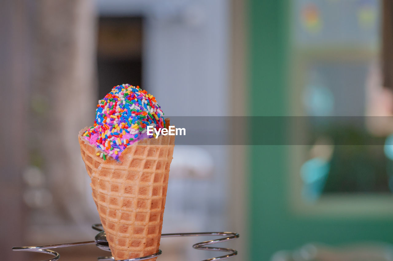 Close-up of ice cream cone with colorful sprinkles