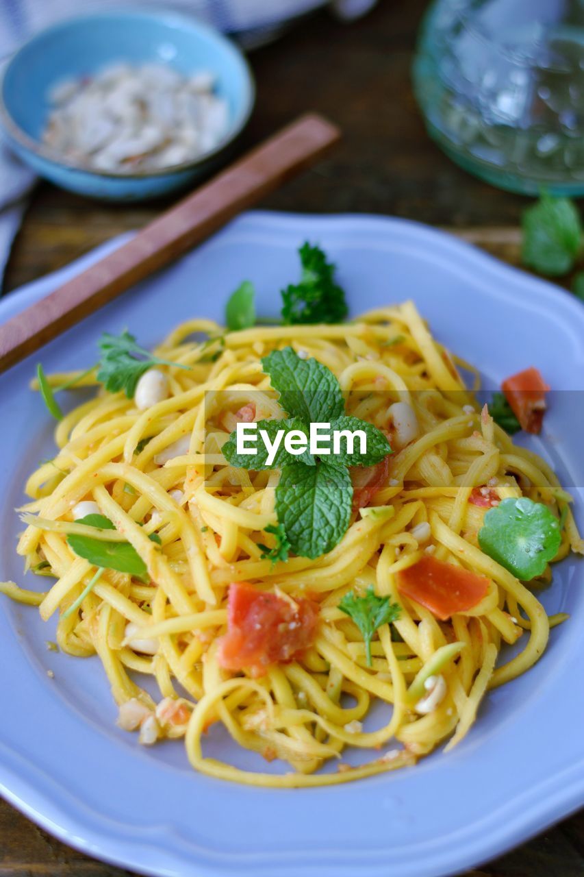 High angle view of raw mango salad  served in plate