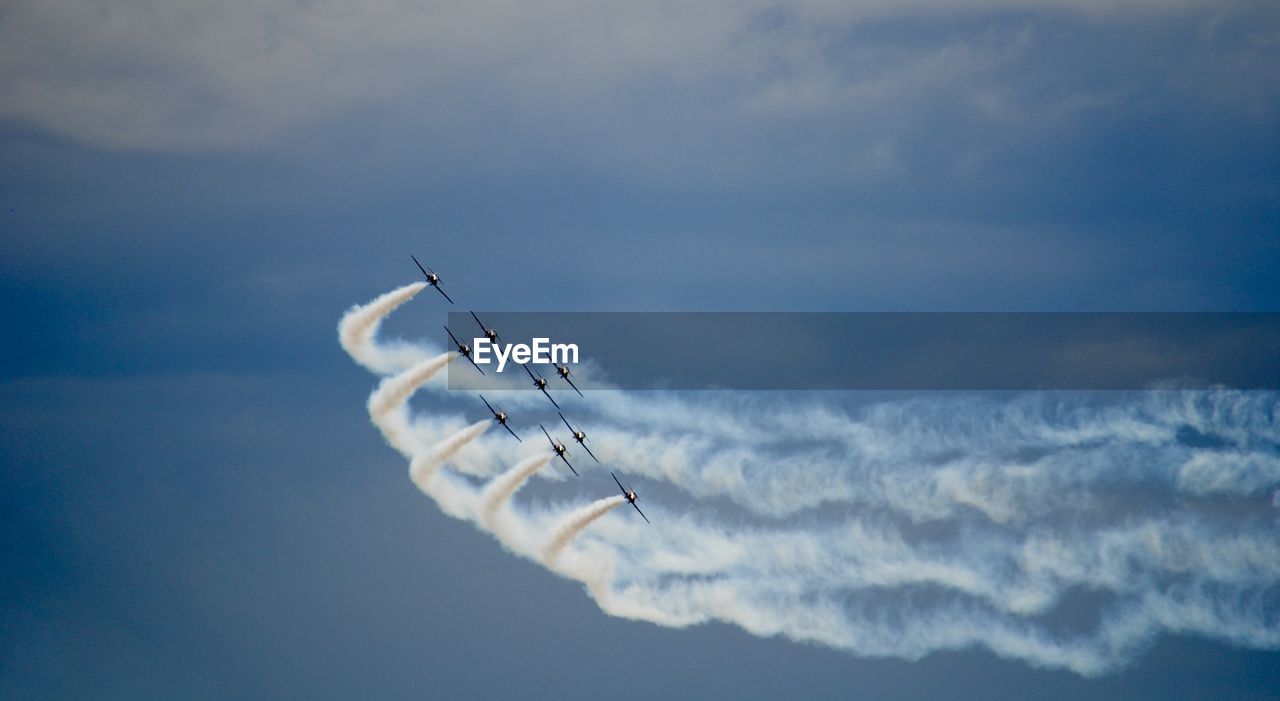 Low angle view of airshow in sky