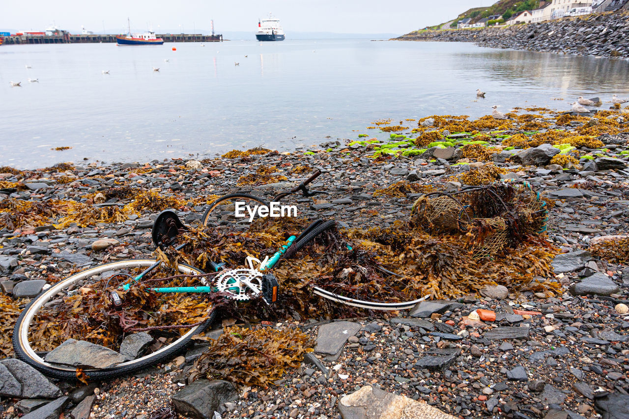 Abandoned bicycle on a rocky beach