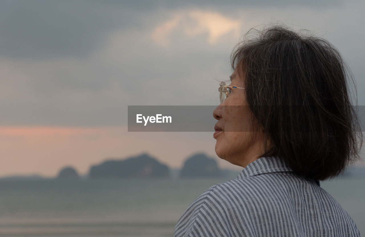 Portrait of woman looking at sunset