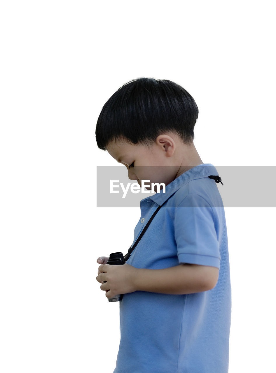 BOY LOOKING AT WHITE BACKGROUND