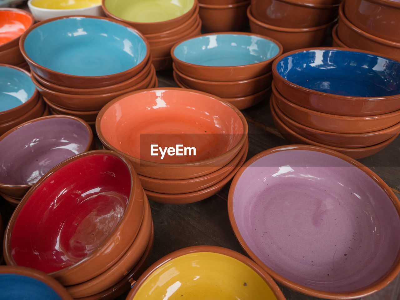 High angle view of multi colored bowls on table