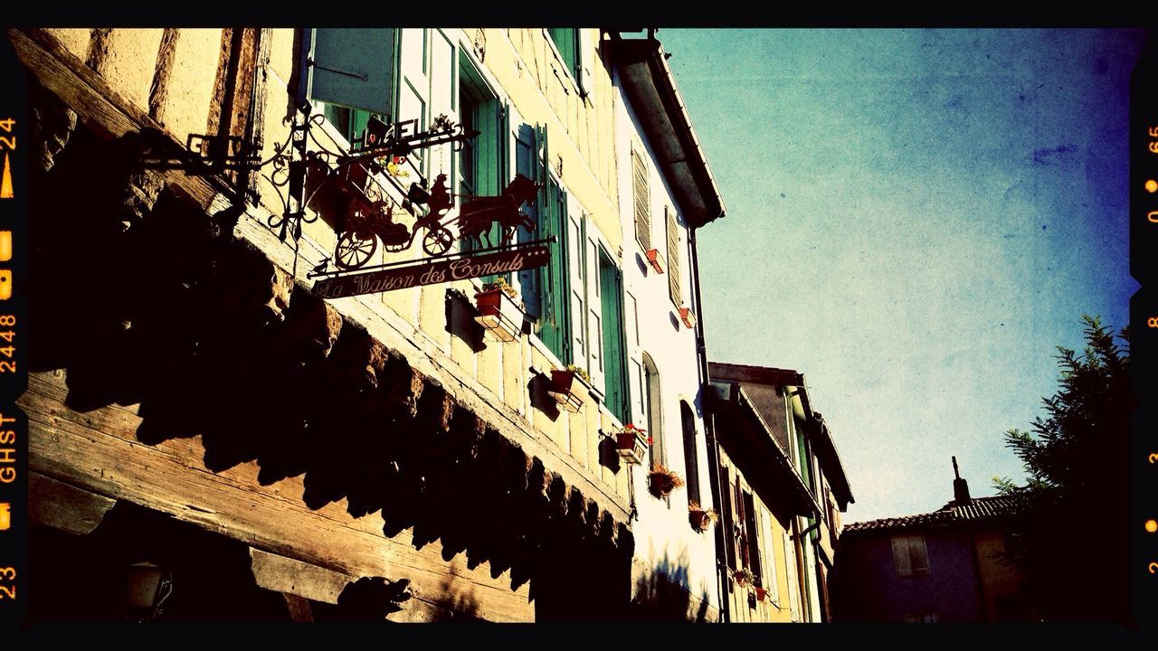 Low angle view of houses in city against sky