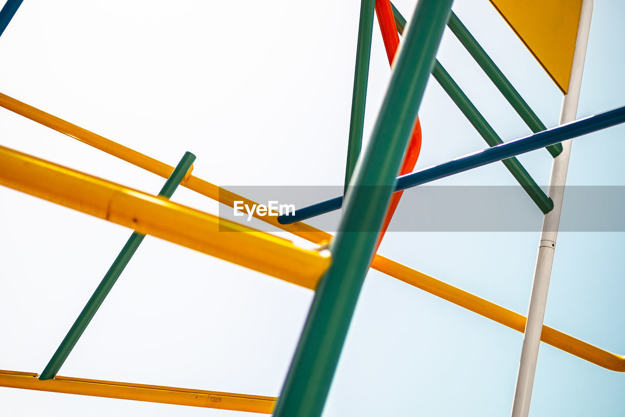 LOW ANGLE VIEW OF MULTI COLORED UMBRELLAS AGAINST SKY