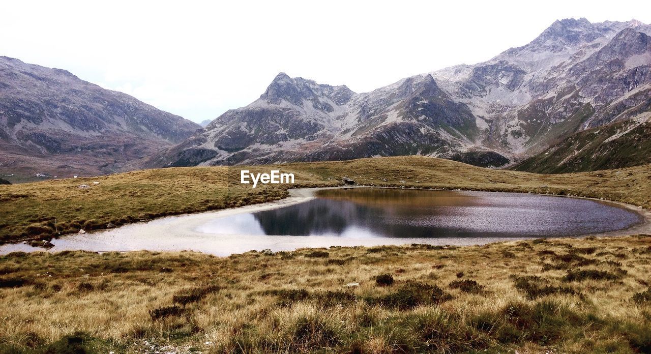 Scenic view of lake and mountains against sky