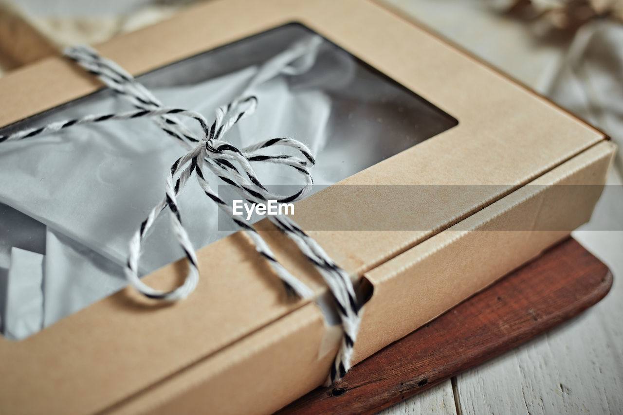 box, wedding favors, gift, celebration, paper, ribbon, indoors, no people, bow, container, gift box, close-up, event, tied bow, still life, table, brown, emotion, selective focus, christmas, wrapping paper, focus on foreground, studio shot, package