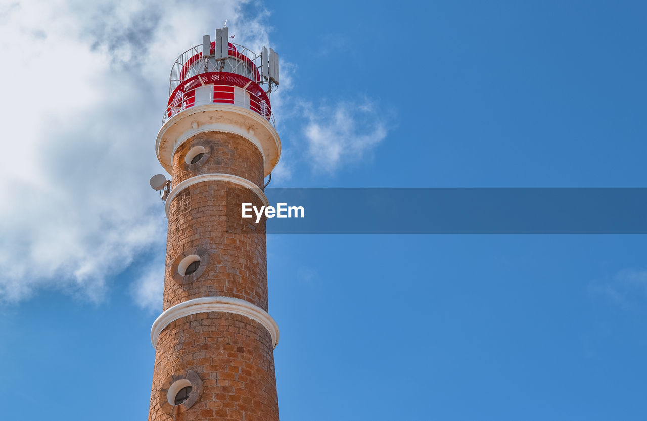 Low angle view of lighthouse against building